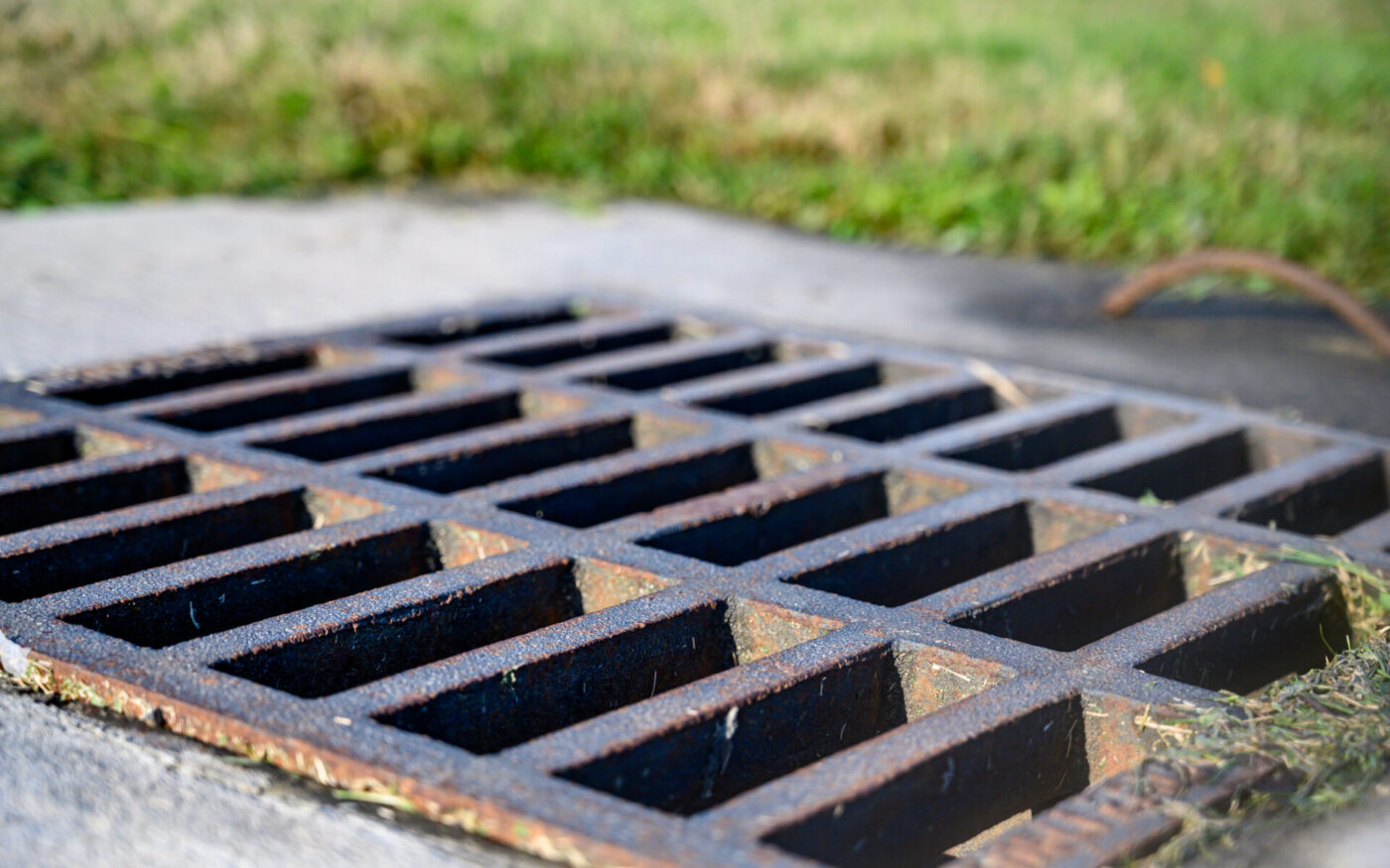 Storm water cast iron grate over collection piping